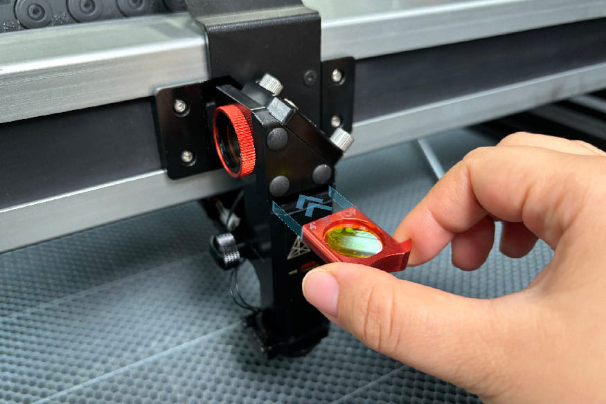 Hand adjusting a small component on a machine with a metallic surface